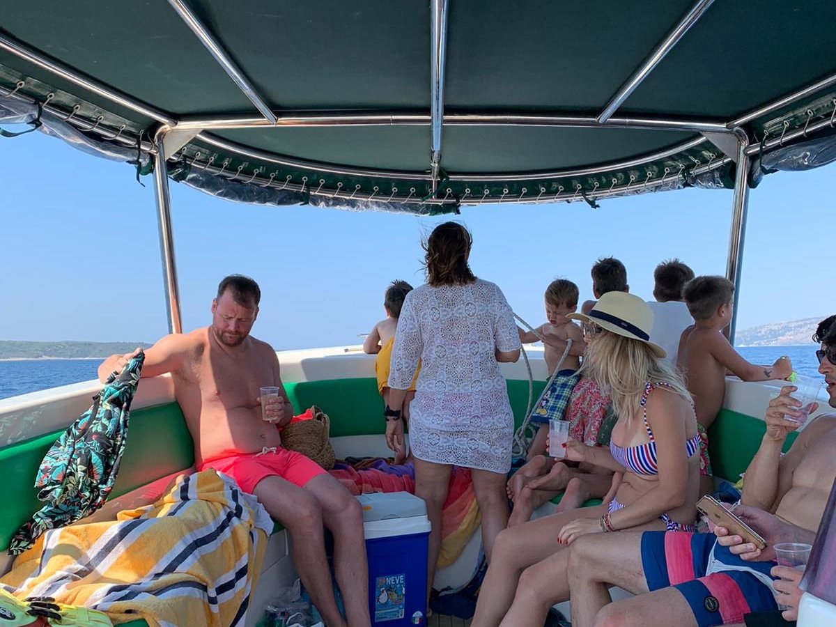 Passengers under covered seating on the Enzo 35 from Split