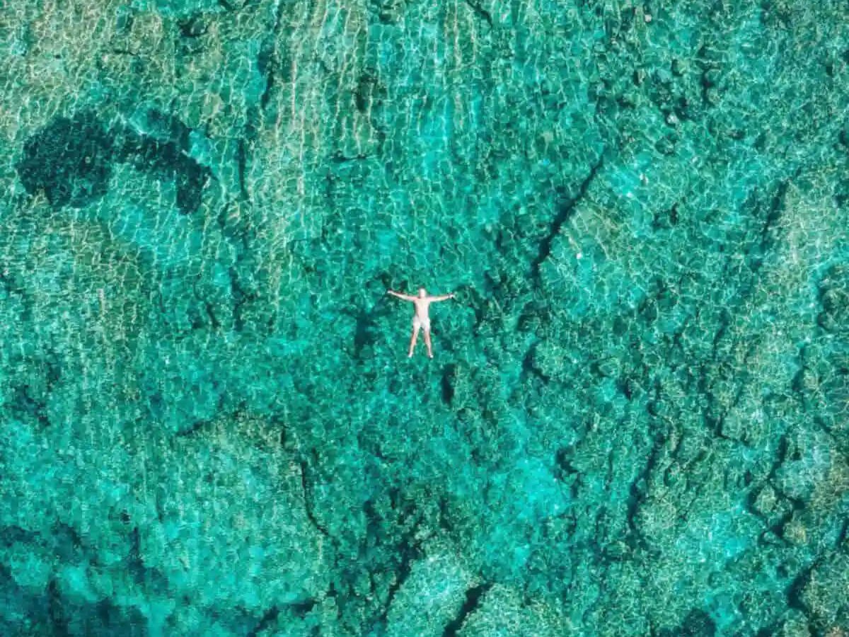 Guests floating in clear Adriatic water on a Blue Cave tour from Split