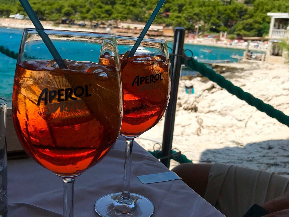 Aperol Spritz cocktails on the terrace overlooking the bay in Milna