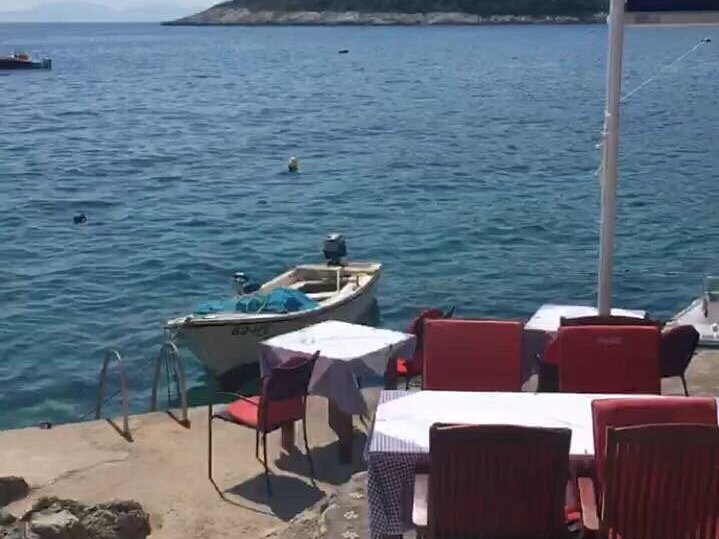 Waterfront terrace with checkered cloths and boats in Milna on Hvar