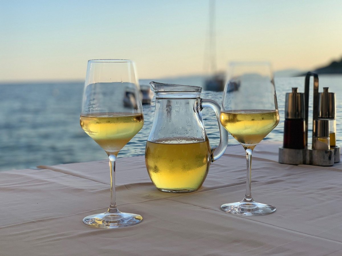 White wine on the table with dusk sea view at the Milna lunch stop