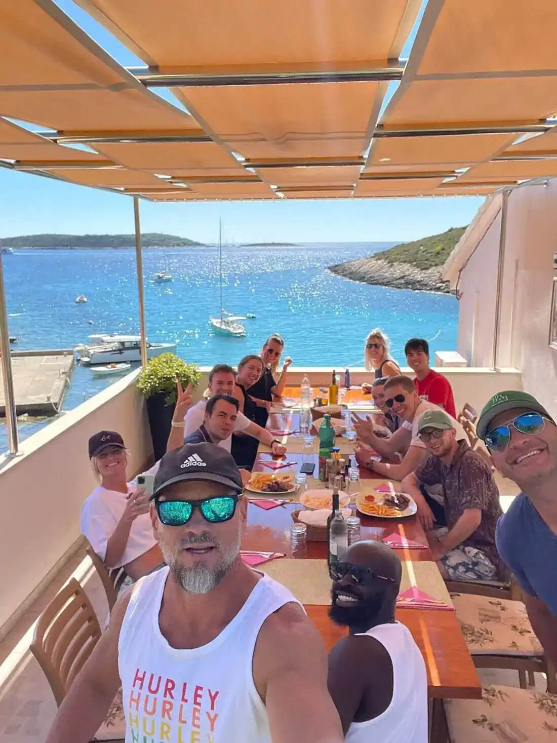 Gäste genießen ein All-Inclusive-Mittagessen in einem privaten Sommerhaus auf der Blue Cave Tour ab Split
